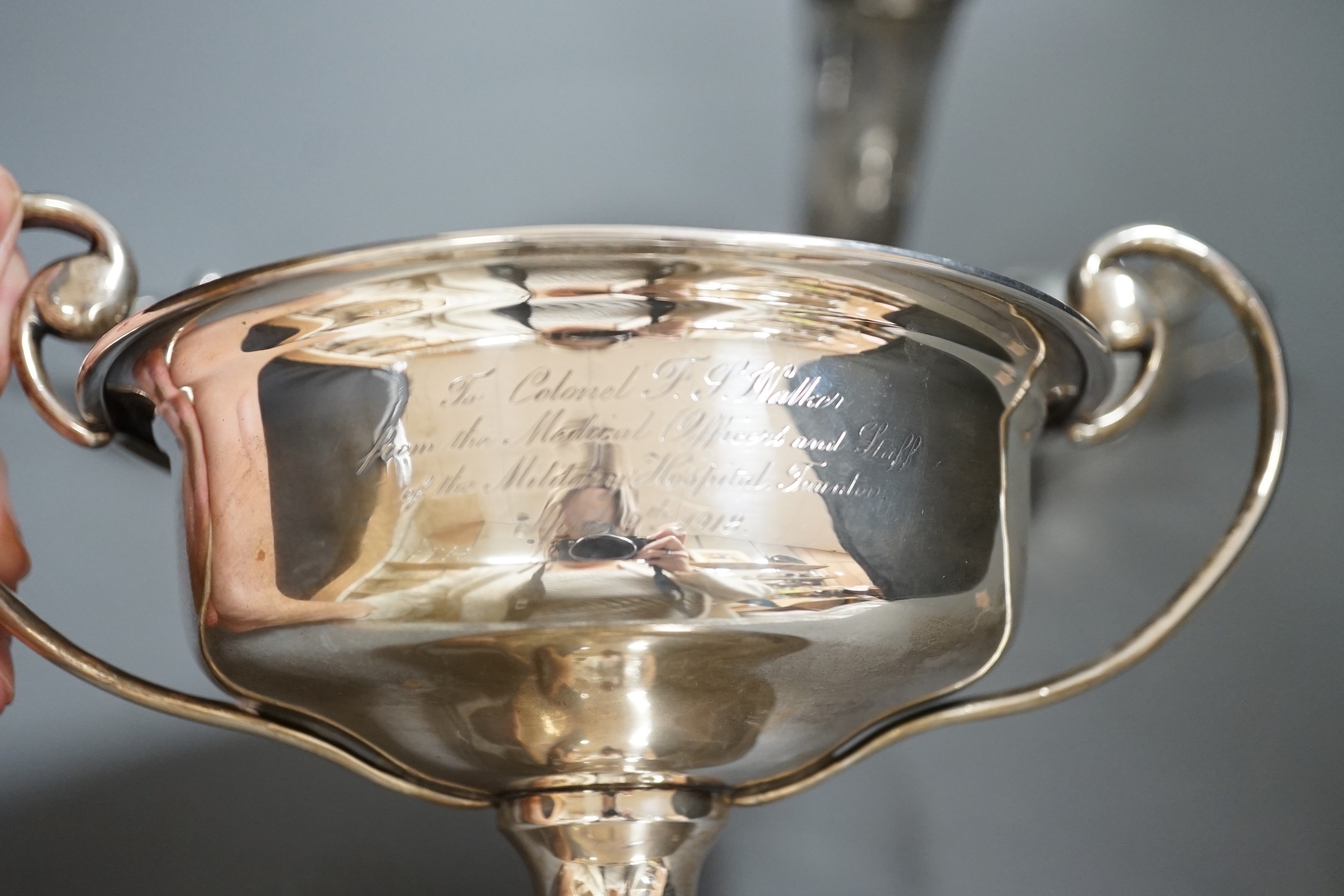 A group of assorted small silver items to include a posy vase, silver-mounted cut glass quaich, a twin-handled silver cup and three condiments.